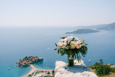 Scenic view of sea and mountains against sky