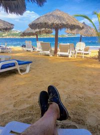 Low section of woman relaxing on beach