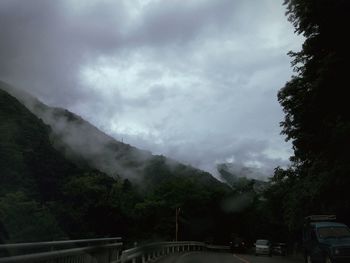 Scenic view of mountains against cloudy sky