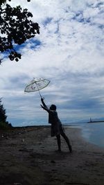 Man on beach against sky