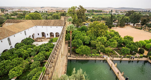 High angle view of buildings and gardens and ornamental pool