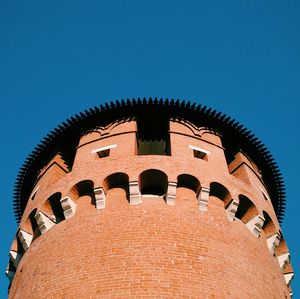 Low angle view of built structure against clear blue sky