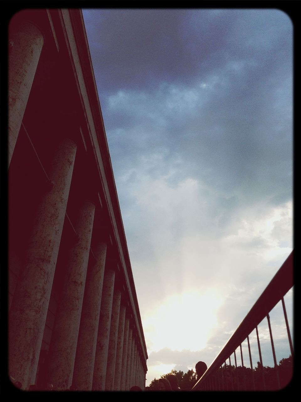 transfer print, sky, low angle view, auto post production filter, cloud - sky, built structure, architecture, cloudy, cloud, building exterior, outdoors, railing, no people, day, transportation, bridge - man made structure, red, part of, metal, sunlight