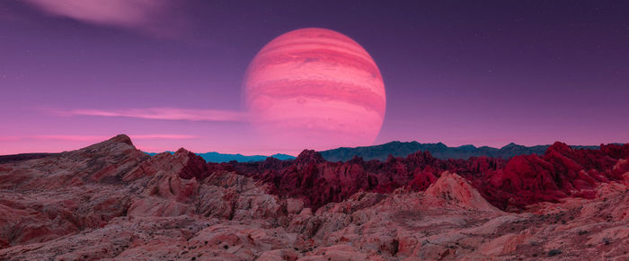 Scenic view of mountains against sky at night