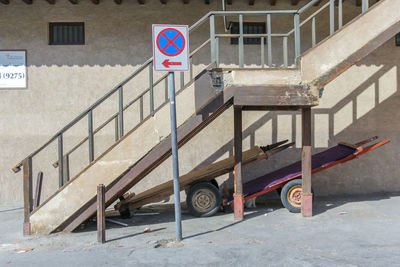 Road sign on street against buildings in city