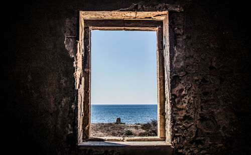 Scenic view of sea against sky seen through entrance