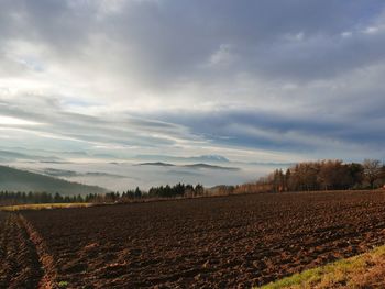 Scenic view of landscape against cloudy sky