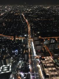 High angle view of illuminated city buildings at night