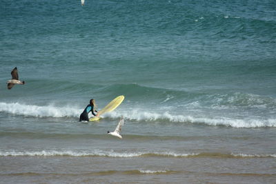 Woman surfing in sea