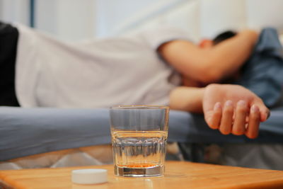 Midsection of man sleeping on table