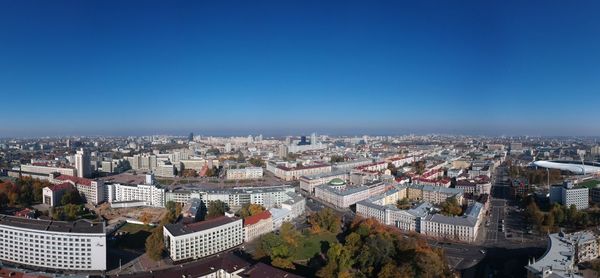 High angle view of buildings against blue sky