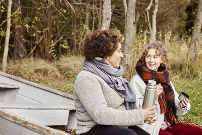 Female friends drinking from insulated drink container