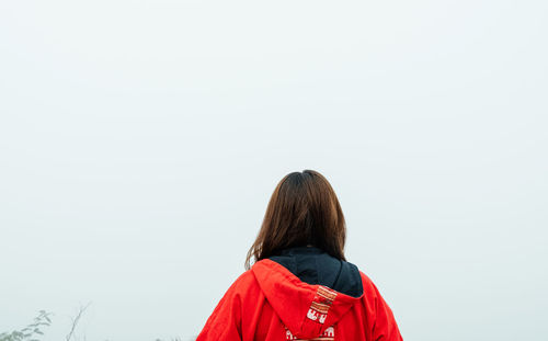 Rear view of woman standing against clear sky