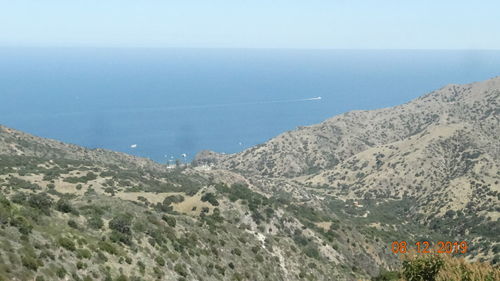 High angle view of sea and mountains against clear sky