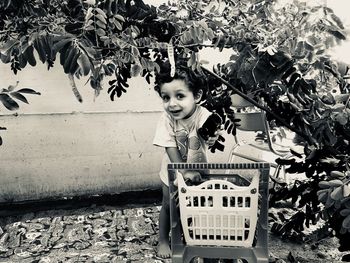 Portrait of girl standing against plants