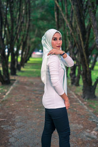 Portrait of woman standing in forest