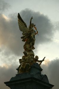 Low angle view of statue against cloudy sky