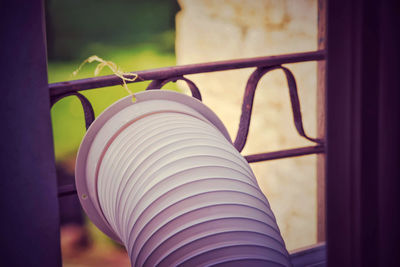 Close-up of spiral wire hanging on metal fence