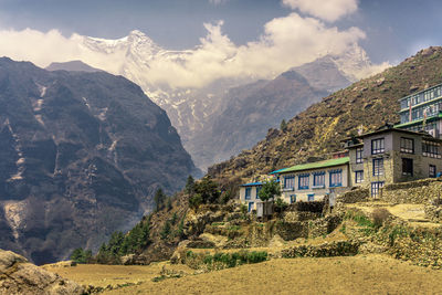 Panoramic shot of houses and mountains against sky