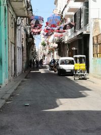 Cars on road amidst buildings in city