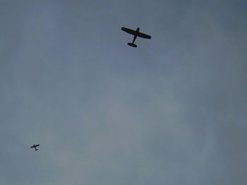 Low angle view of helicopter flying in sky