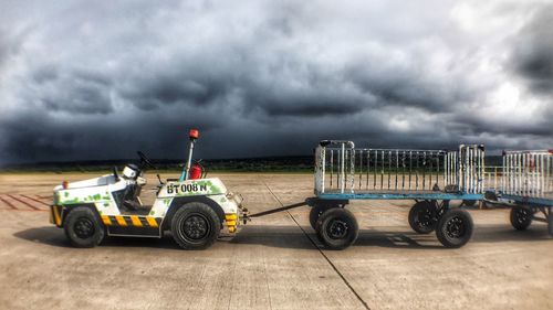 Vintage car against cloudy sky