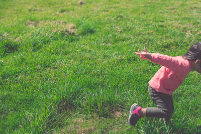 Rear view of girl on field