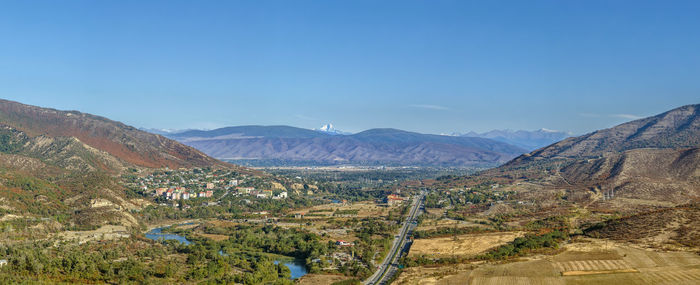 Scenic view of mountains against blue sky