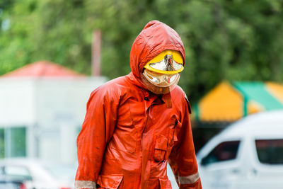 Firefighter wearing protective workwear while standing outdoors