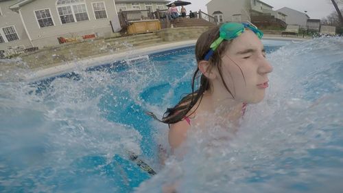 Close-up of teenage girl swimming in pool