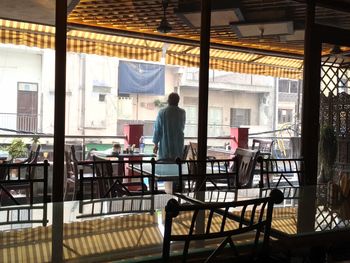 Rear view of man standing in restaurant