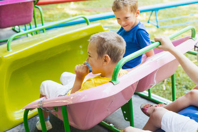 Children playing on swing in playground