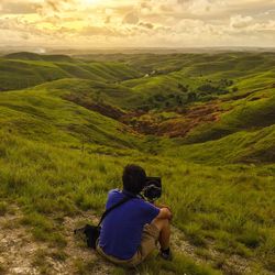 Rear view of man on landscape against sky