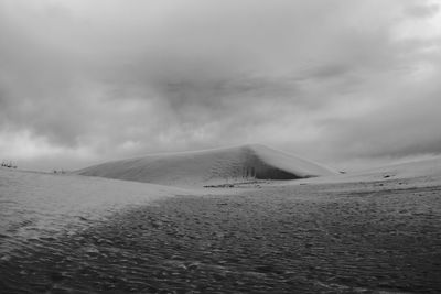 Scenic view of desert against sky during winter