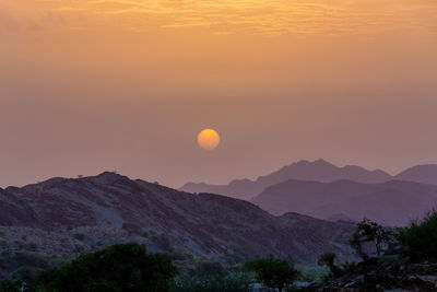 Scenic view of mountains against sky during sunset