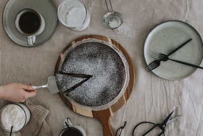 Woman cutting freshly baked chocolate cake