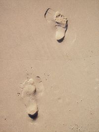 High angle view of footprints on sand