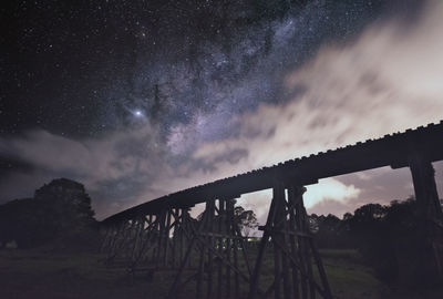 Low angle view of bridge against sky at night