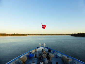 Scenic view of lake against clear blue sky