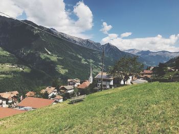 Houses by mountains against sky