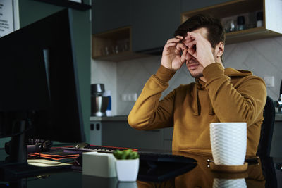 Man procrastinate at home workplace, remote work problem