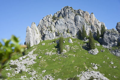 View of rocks on mountain against clear sky