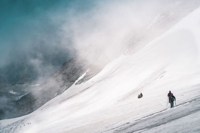 People skiing on snowcapped mountain