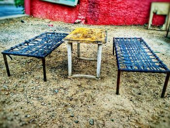 High angle view of empty chairs and table on field