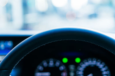 Close-up of control seen through car windshield