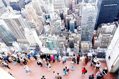 High angle view of people walking on street amidst buildings in city