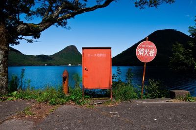 Road sign and fuse box at lakeshore