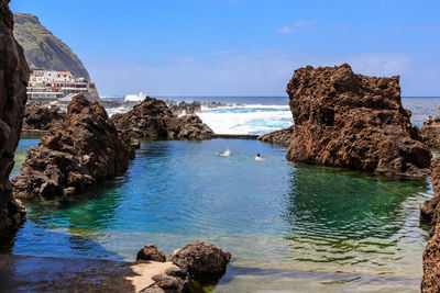 Panoramic view of pool rocks against the sky