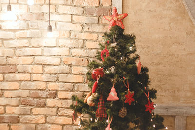 Red christmas tree against wall