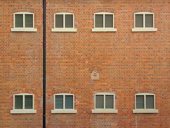 Clown on the red brick wall 